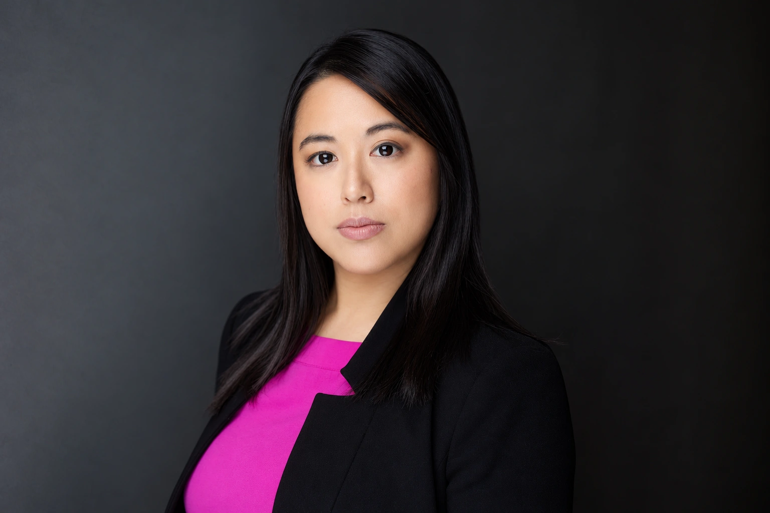 Tiffany Iris — Dramatic headshot in a black blazer and pink top
