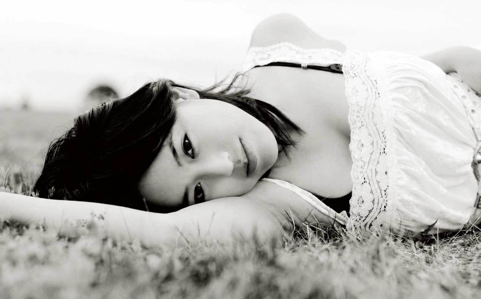 Tiffany Iris reclining in grass, black-and-white portrait
